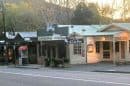 View of Sassafras village shops and cafes in the Dandenong Ranges at sunset.