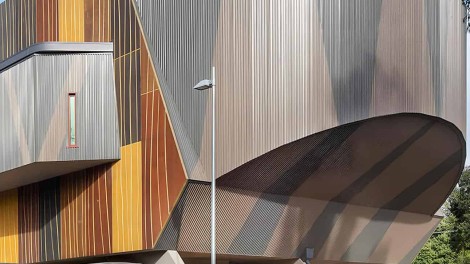 Modern building with curved and angular wooden and metal exterior at Burrinja Cultural Centre.