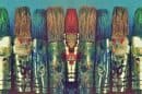 A row of colourful paint tubes arranged on a shelf.