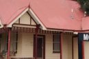Mount Evelyn train station with a red roof and Mount Evelyn sign in Victoria.