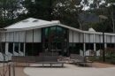 Modern building with large glass windows and surrounding paved area in Montrose.