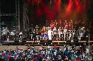 Outdoor concert stage with musicians performing at Knox Carols event in Victoria.
