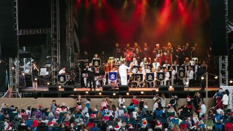 Outdoor concert stage with musicians performing at Knox Carols event in Victoria.